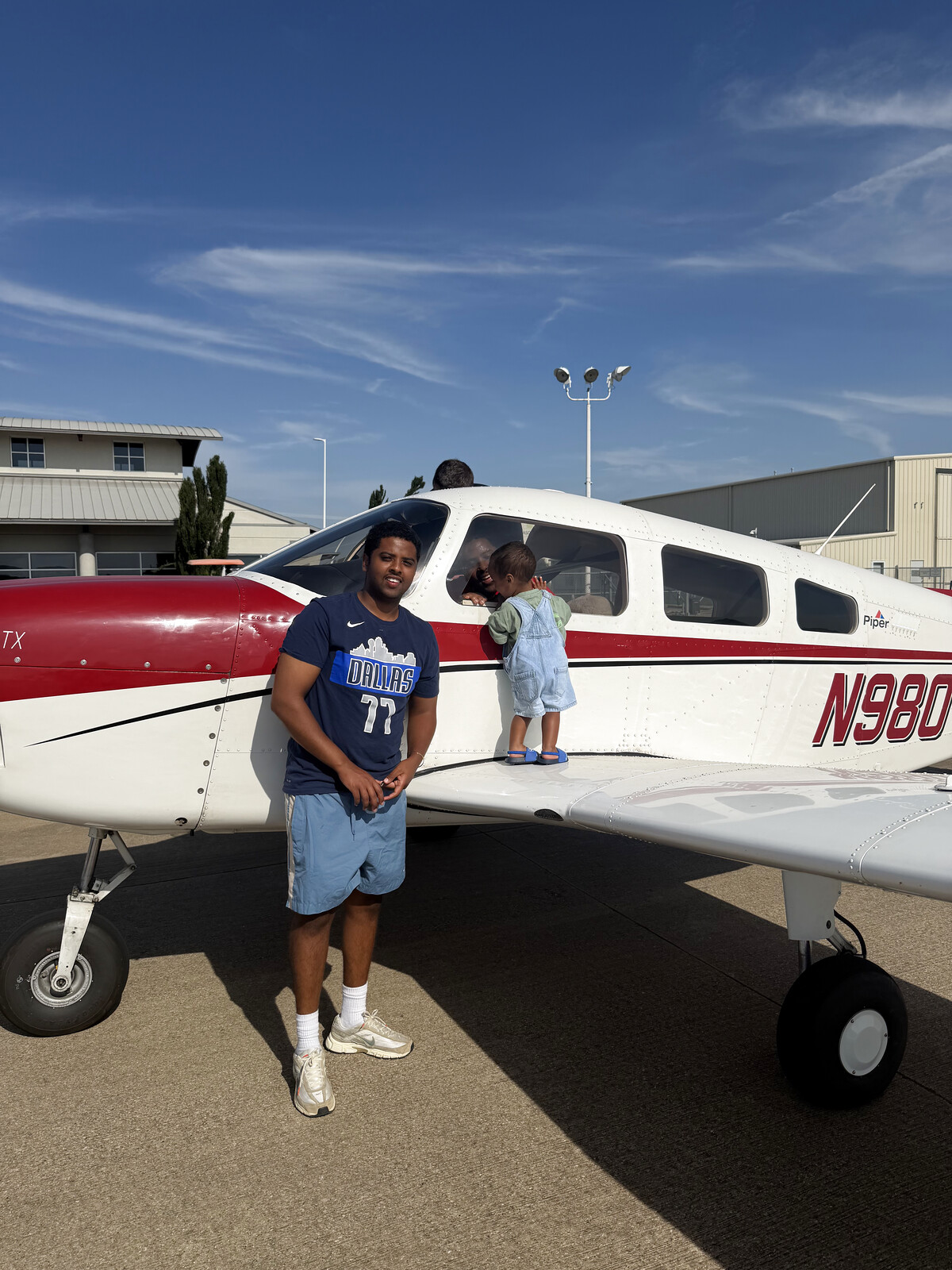 Amor Daniel, owner of Lone Star Junk Removal and student pilot, standing beside an airplane